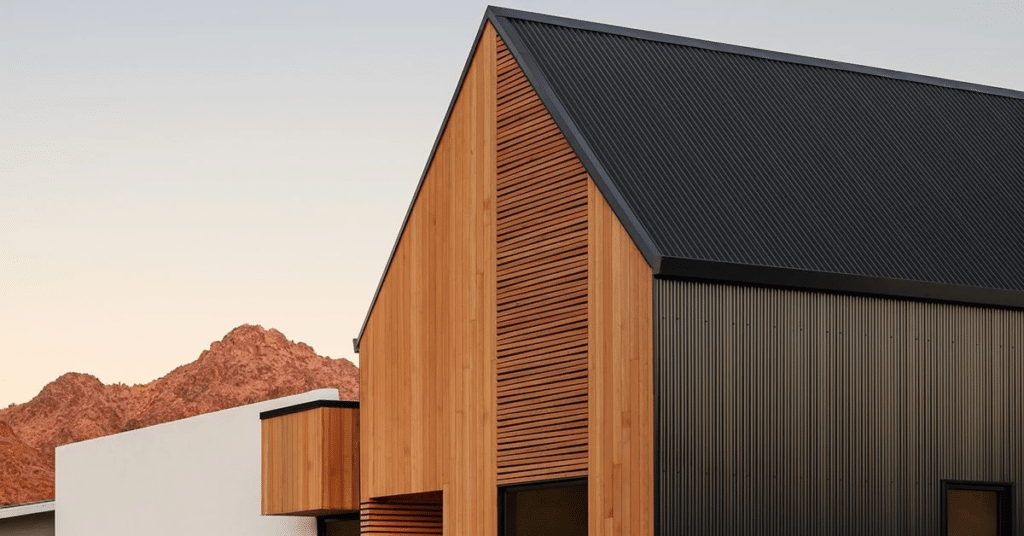 Modern wood-clad home with black metal gable roof
