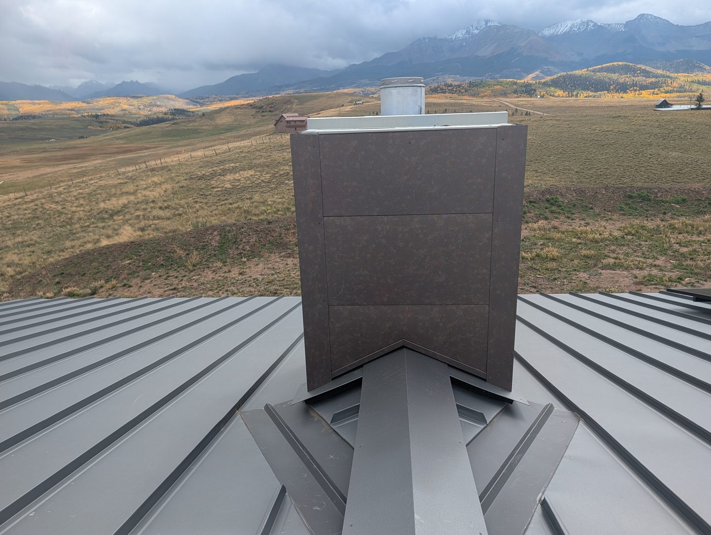 Chimney chase cricket and flashing on a standing seam metal roof