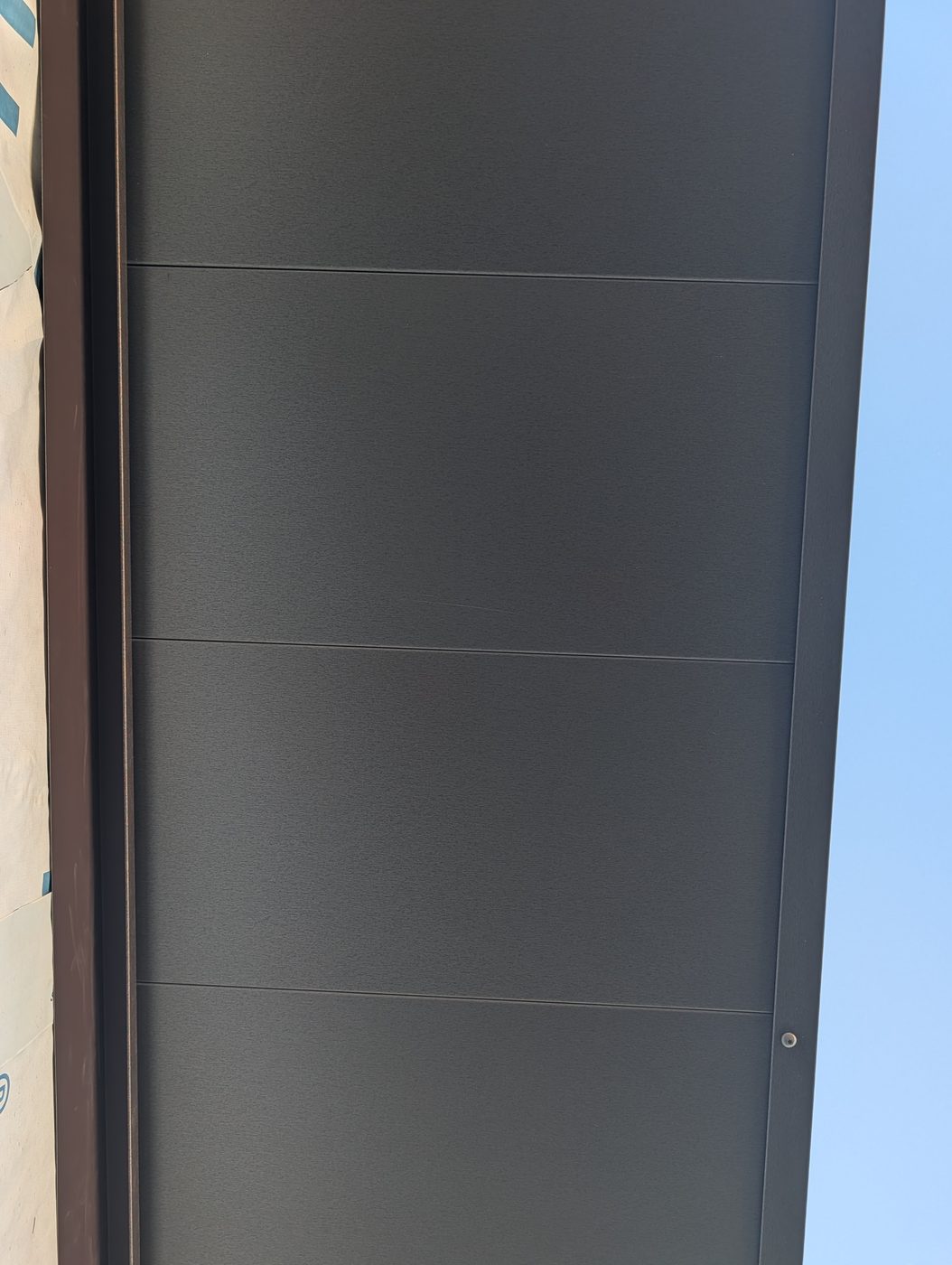Finished metal soffit panels under the eave